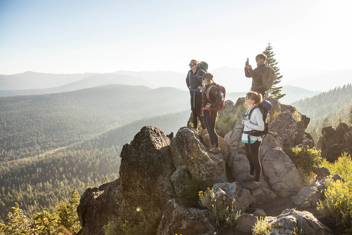 Group of people standing at top of mountain